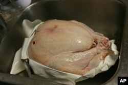 Thanksgiving’s main dish, before cooking. The pop-up timer is primed for action.