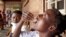 FILE - Eliza Tangwe, 18, takes a dose of oral cholera vaccine at a health center in response to a cholera outbreak in Blantyre, Malawi, November 16, 2022. 