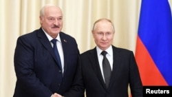 FILE PHOTO: Russian President Vladimir Putin meets with Belarusian President Alexander Lukashenko outside Moscow
