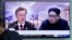 People watch a TV screen showing file footage of South Korean President Moon Jae-in and North Korean leader Kim Jong Un during a news program ahead of the inter-Korean summit at the Seoul Railway Station in Seoul, South Korea, April 26, 2018. 