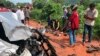 In this photo provided by Cambodia National Police, onlookers stand around the mangled wreckage of Cambodia's Prince Norodom Ranariddh's car after a collision with another vehicle outside Sihanoukville, Cambodia, Sunday, June 17, 2018. Ranariddh has been seriously injured in the road crash that killed his wife and injured at least seven other people early Sunday. (Cambodia National Police via AP)