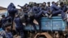 Congolese police officers board trucks after an enrollment of civilians, police officers, and former members of the Armed Forces of the Democratic Republic of Congo who allegedly decided to join the M23 movement voluntarily in Bukavu, Democratic Republic of Congo, Feb. 22, 2025.