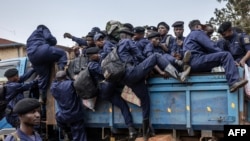 Congolese police officers board trucks for redeployment following an enrollment of civilians, police officers, and former members of the Armed Forces of the Democratic Republic of Congo (FARDC) who allegedly decided to join the M23 movement voluntarily in