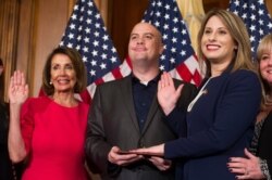 FILE - House Speaker Nancy Pelosi of Calif., right, poses during a ceremonial swearing-in with Rep. Katie Hill, D-Calif., on Capitol Hill in Washington, Jan. 3, 2019.