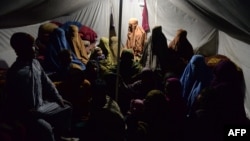 Women with their children sit inside a tent on the outskirts of Jalalabad, in Afghanistan's Nangarhar province, Jan 18, 2017. A number of women from the province were captured by Islamic State fighters in early 2016 and held for more than four months before they were released as part of prisoner-swap.