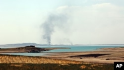 Smoke rises during airstrikes targeting Islamic State militants at the Mosul Dam outside Mosul, Iraq, Aug.18, 2014.