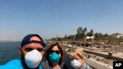 This photo provided by Javier Parodi, shows a selfie of Javier Parodi, left, Grissel Parodi and Amy Khamissian, on board the Nile cruise ship MS Asarade, in Luxor, Egypt, March 10, 2020.