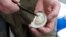 Oysterman, Chris Ludford, opens one of his oysters taken from his leased oyster beds on the Lynnhaven River in Virginia Beach, Virginia, Feb. 23, 2017. 