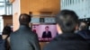 People watch a TV screen broadcasting South Korean President Yoon Suk Yeol delivering an address to the nation, at a railway station in Seoul, South Korea, Dec. 12, 2024.