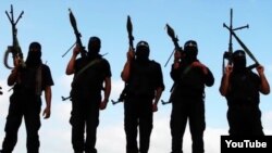 FILE - Armed Islamic State jihadists are seen in a screen grab from a propaganda video.