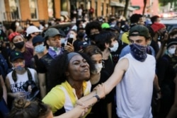 Protesters clash with New York police officers during a demonstration, May 30, 2020, in the Brooklyn borough of New York.