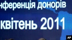 France's Prime Minister Francois Fillon, left, Ukrainian President Viktor Yanukovych, center, and President of the European Commission Jose Manuel Barroso during the Chernobyl Pledging Conference in Kiev, Ukraine, Tuesday, April 19, 2011.