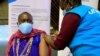 FILE - Kenyan tour guide, Daniel Ole Kissipan, receives a shot of the AstraZeneca/Oxford vaccine in Nairobi, Kenya, April 27, 2021.