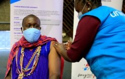 FILE - Kenyan tour guide, Daniel Ole Kissipan, receives the AstraZeneca/Oxford vaccine in Nairobi, Kenya, April 27, 2021.