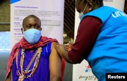 FILE - Kenyan tour guide, Daniel Ole Kissipan, receives the AstraZeneca/Oxford vaccine in Nairobi, Kenya, April 27, 2021.