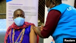 FILE - Kenyan tour guide, Daniel Ole Kissipan, receives a shot of the AstraZeneca/Oxford vaccine in Nairobi, Kenya, April 27, 2021.