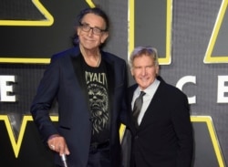 FILE - This December 16, 2015 file photo shows Peter Mayhew, left, and Harrison Ford at the European premiere of the film 'Star Wars: The Force Awakens ' in London.