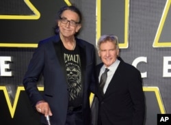 FILE - This December 16, 2015 file photo shows Peter Mayhew, left, and Harrison Ford at the European premiere of the film 'Star Wars: The Force Awakens ' in London.