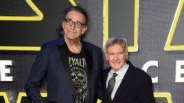 FILE - This December 16, 2015 file photo shows Peter Mayhew, left, and Harrison Ford at the European premiere of the film 'Star Wars: The Force Awakens ' in London.