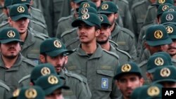FILE - Iranian Revolutionary Guard members attend a ceremony celebrating the 40th anniversary of the Islamic Revolution, at the Azadi, or Freedom, Square in Tehran, Iran, Feb. 11, 2019.