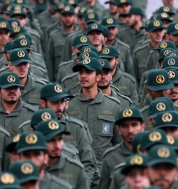 FILE - Iranian Revolutionary Guard members attend a ceremony celebrating the 40th anniversary of the Islamic Revolution, Feb. 11, 2019, at the Azadi, or Freedom, Square in Tehran, Iran.