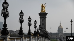 A picture taken on March 20, 2020 in Paris, shows a deserted bridge Pont Alexandre III, on the fourth day of a strict lockdown in France aimed at curbing the spread of COVID-19. 