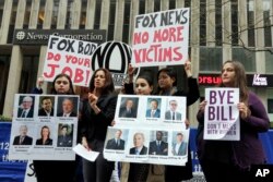 Sonia Ossorio, second left, president of the National Organization for Women New York, speaks outside the News Corporation headquarters in New York, April 20, 2017, a day after Fox News Channel's Bill O'Reilly was fired.