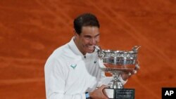 Spain's Rafael Nadal celebrates winning the final match of the French Open tennis tournament against Serbia's Novak Djokovic in three sets, 6-0, 6-2, 7-5, at the Roland Garros stadium in Paris, France, Oct. 11, 2020.