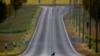 A crow crosses an empty road in Frankfurt, Germany.