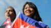 Cambodia's Ambassador to Washington DC, Hem Heng, far left, joins in to celebrate the flag ceremony in Philadelphia. 