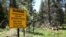 FILE - A warning sign is seen for hikers entering the area burned in the 2007 Angora fire, near South Lake Tahoe, Calif., July 6, 2010.