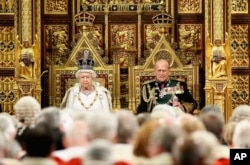 FILE - Britain's Queen Elizabeth II and Prince Philip sit in the House of Lords ahead of the Queen's Speech at the State Opening of Parliament in London, May 18, 2016.