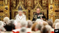 Britain's Queen Elizabeth II and Prince Philip, sit in the House of Lords ahead of the Queen's Speech at the State Opening of Parliament in London, May 18, 2016. 