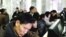 Former New Mexico Governor Bill Richardson (C, back row) looks at North Koreans working on computers at the Grand People's Study House in Pyongyang, January 9, 2013 in this picture released by the North Korea's KCNA news agency. 