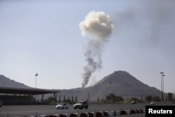 FILE - Smoke rises from an army weapons depot hit by a Saudi-led airstrike in al-Nahdain mountain in Yemen's capital, Sana'a, Oct. 25, 2015.