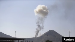 FILE - Smoke rises from an army weapons depot hit by a Saudi-led airstrike in al-Nahdain mountain in Yemen's capital, Sanaa, Oct. 25, 2015. 