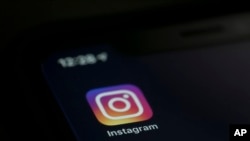 The Instagram app is displayed on a computer on Aug. 23, 2019, in New York. Over the last day, several Instagram accounts run by abortion rights advocacy groups discovered that some of their content mentioning abortion has been hidden from public view or labeled "sensitive."