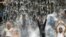 Pakistani youth crowd a water fall in a park to beat the heat in Lahore. Severe heat wave conditions continue over most plains of the Punjab province.