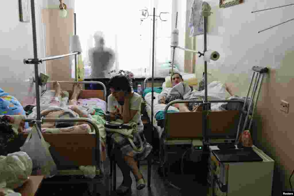 Soldiers of the Ukrainian Army who were injured while fighting against separatists in Eastern Ukraine, lie on hospital beds in a ward at the Central Clinical Hospital of the Ministry of Defense of Ukraine, in Kyiv, June 13, 2014.