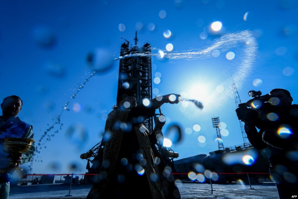 A Russian Orthodox priest blesses the Soyuz MS-12 spacecraft at the launch pad of the Russian-leased Baikonur cosmodrome in Kazakhstan.
