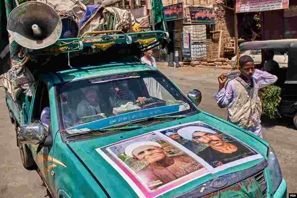 Sheikh Mohamed Taha decorates his car with palm leaves, posters of Sufi monks and loudspeakers. (H. Elrasam/VOA)