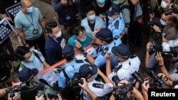 Pro-democracy lawmaker Wu Chi-wai scuffles with police during a march against new security laws, near China's Liaison Office, in Hong Kong, China May 22, 2020. (REUTERS/Tyrone Siu)