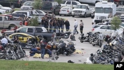 Authorities investigate a shooting in the parking lot of the Twin Peaks restaurant in Waco, Texas, May 17, 2015.