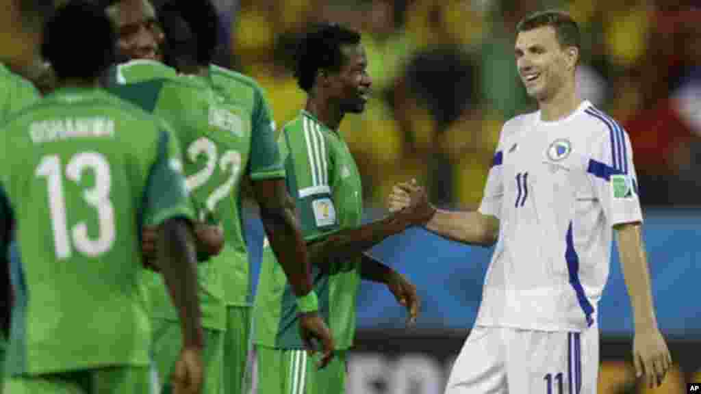 Nigeria's Efe Ambrose greets Bosnia's Edin Dzeko.