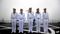 FILE - Chinese sailors stand on the deck of the naval training ship Qi Jiguang during a naval parade to commemorate the 70th anniversary of the founding of China's PLA Navy in the sea near Qingdao in eastern China's Shandong province, Tuesday, April 23, 2019.