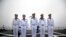 Chinese sailors stand on the deck of the naval training ship Qi Jiguang during a naval parade to commemorate the 70th anniversary of the founding of China's PLA Navy in the sea near Qingdao in eastern China's Shandong province, Tuesday, April 23, 2019.