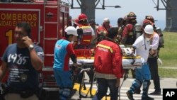 Peru Deadly Fire: Firefighters prepare a stretcher outside Larcomar's shopping mall during a deadly fire in Lima, Peru, Wednesday, Nov. 16, 2016.