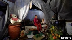 Maria Guadalupe Padilla rests in her tent in the Tlalpan neighbourhood, near the site where her building was damaged by the devastating earthquake, that took place in Mexico City last year, Mexico, Sept. 7, 2018.