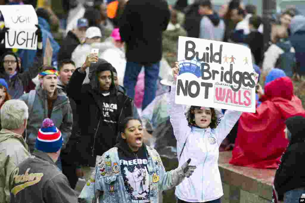 Demonstrators march along the Presidential Inaugural parade route on Pennsylvania Avenue ahead of President-elect Donald Trump being sworn-in as President, Jan. 20, 2017 in Washington. 