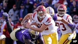 Southern Cal quarterback Matt Fink (19) carries the ball in a NCAA college football game Sept. 28, 2019, in Seattle. The governor of California signed a law Monday that will permit college athletes to hire agents and make endorsement deals. (AP Photo/Elaine Thompson)